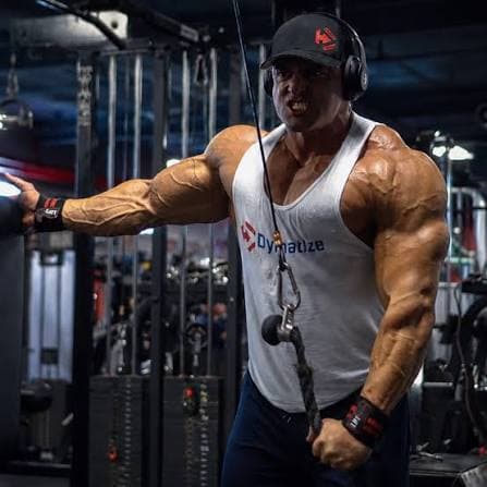 Bodybuilder training with cables in the gym